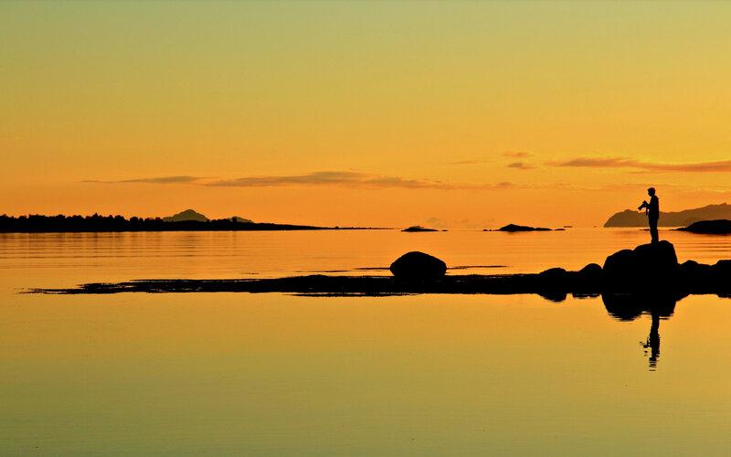 Silhouette of Person on Rock — Orange, Serene