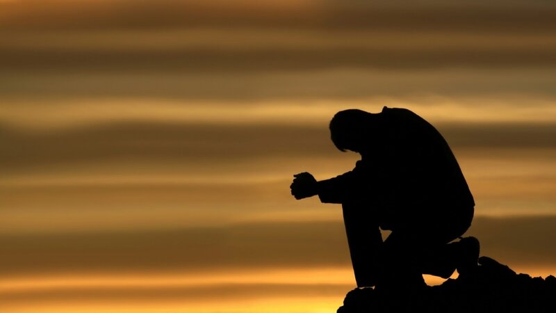 Silhouette of Person Praying — Orange, Dramatic