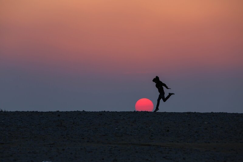 Silhouette of Person Running — Red