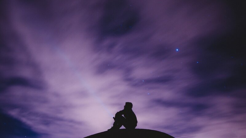 Silhouette of Person Sitting — Purple, Serene, Night