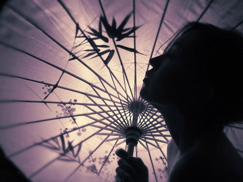 Silhouette of Person under Umbrella