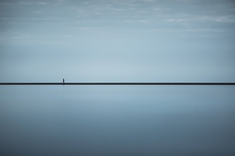Silhouette of Person Walking — Blue, Serene, Photograph