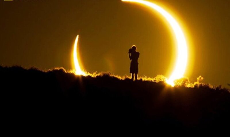 Silhouette of Person Watching Eclipse — Yellow