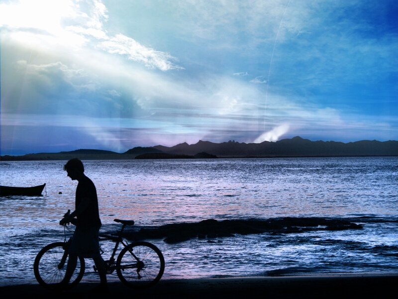 Silhouette of Person with Bicycle