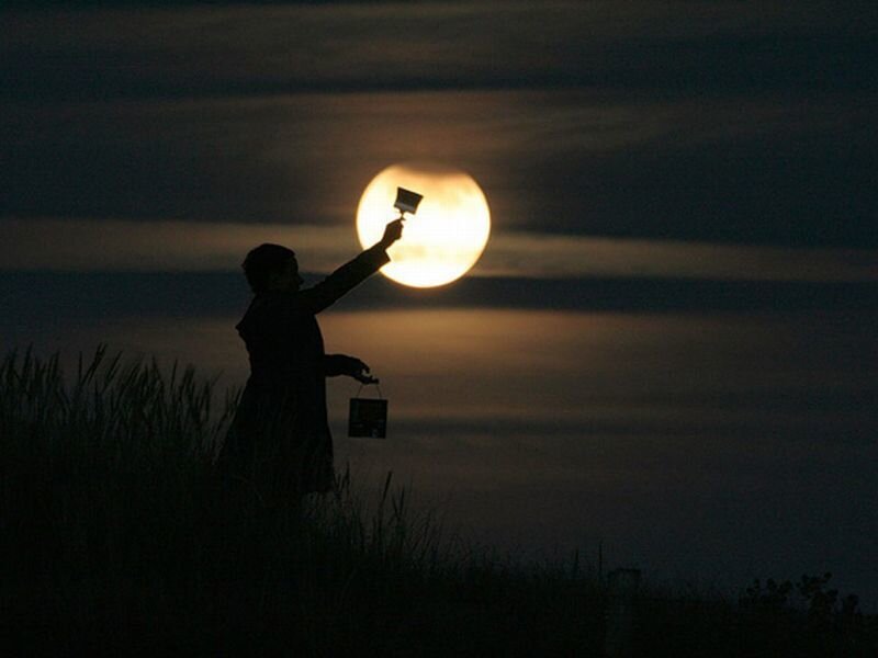 Silhouette of Person with Lantern