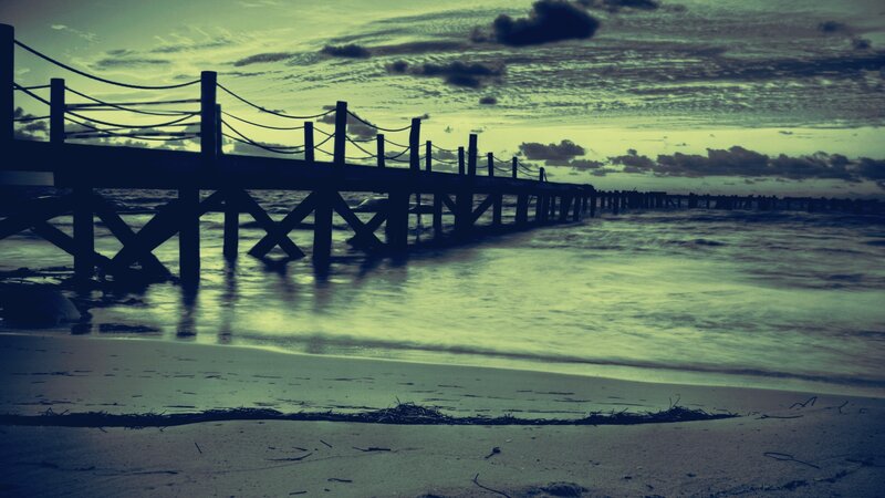 silhouette of pier at dusk