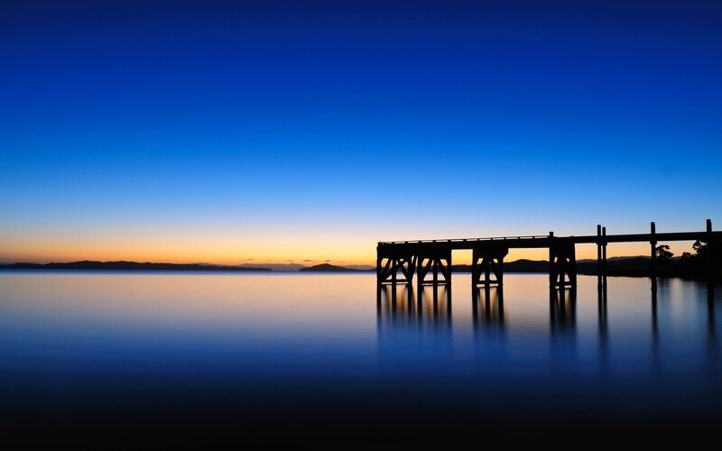 Silhouette of pier at dusk