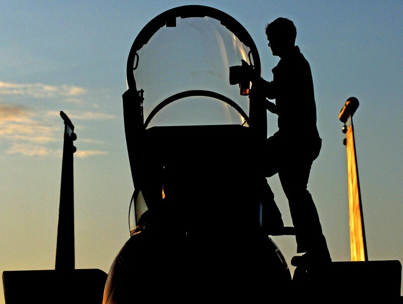 Silhouette of pilot with jet aircraft