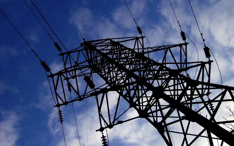 silhouette of power line tower
