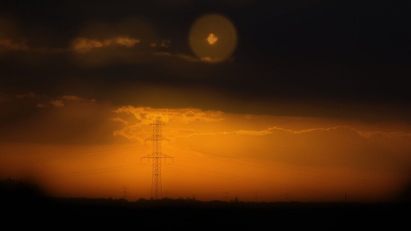 Silhouette of Power Line Tower — Orange