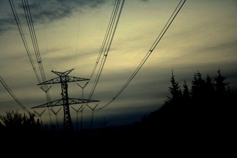 Silhouette of power lines at dusk