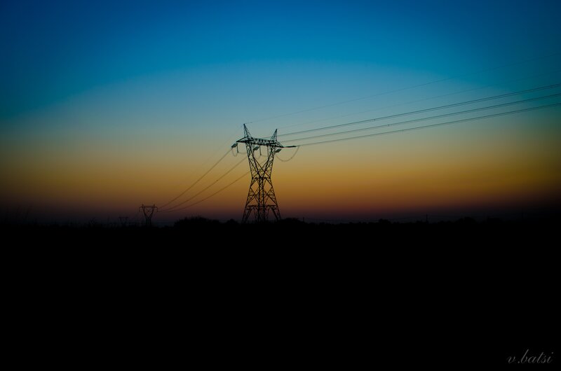 Silhouette of power lines at dusk