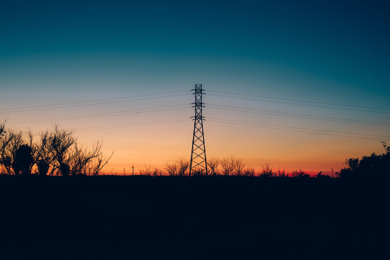 Silhouette of power lines at sunset