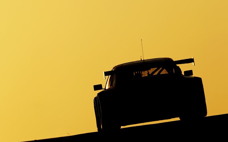 silhouette of race car at sunset