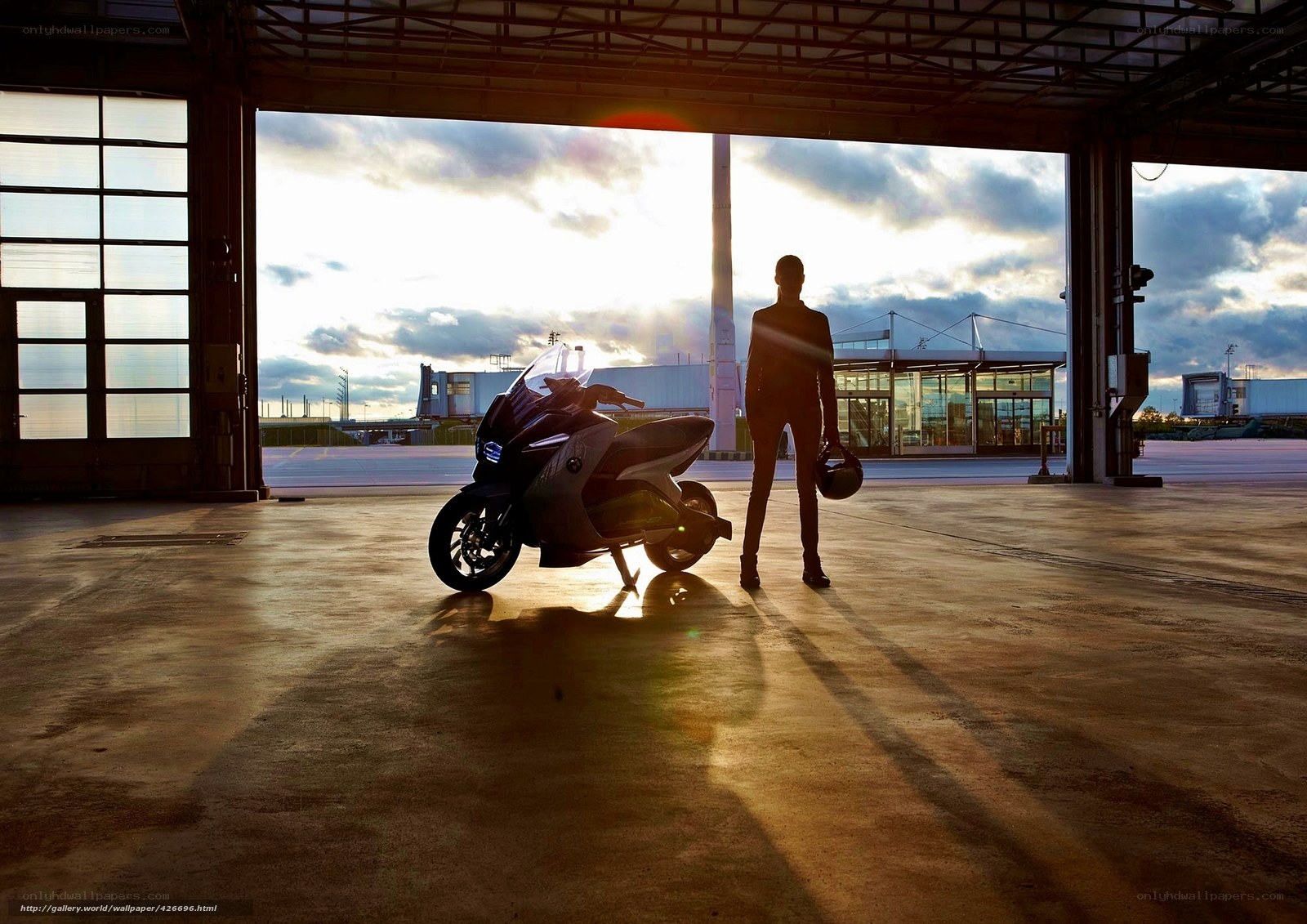 Silhouette of rider and scooter