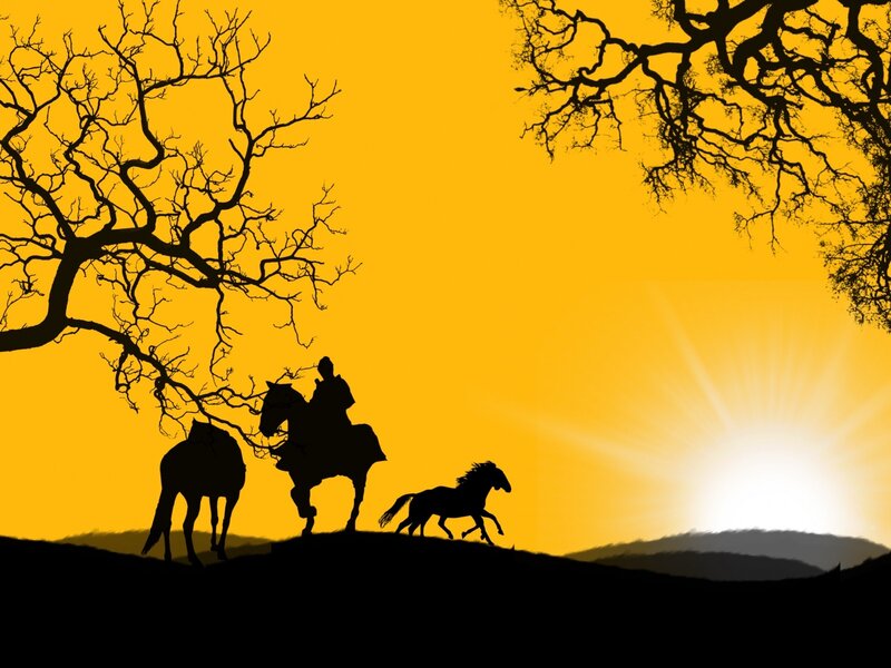 Silhouette of riders at sunset