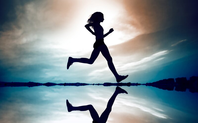 silhouette of runner at sunset