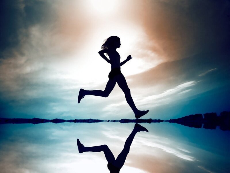 silhouette of runner at sunset