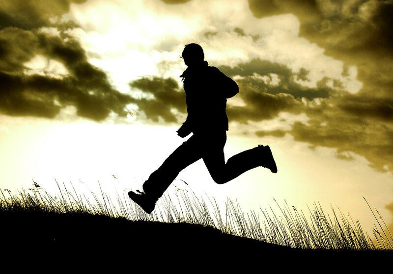 silhouette of runner at sunset