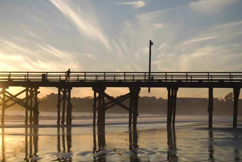 silhouette of runner on pier