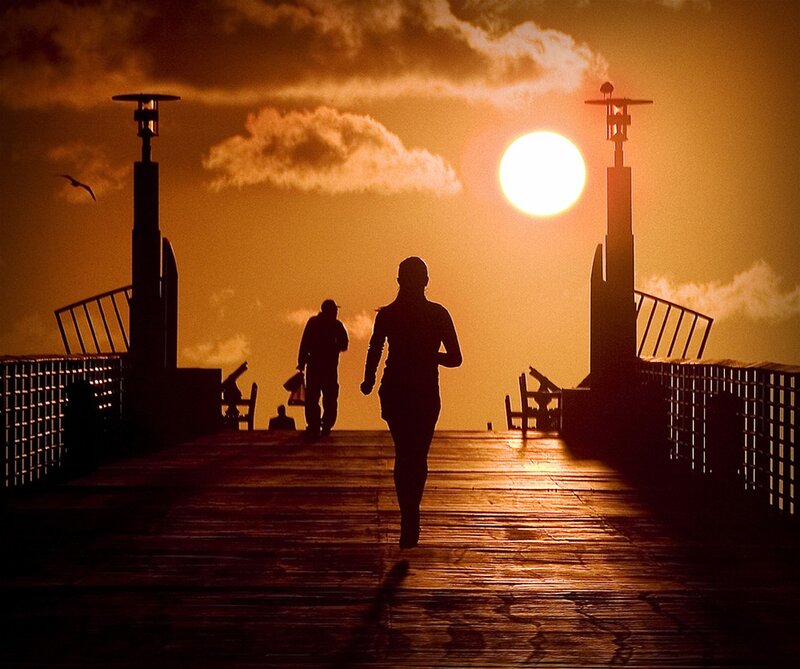 Silhouette of runners at sunset