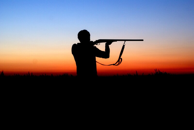 silhouette of shooter at sunset