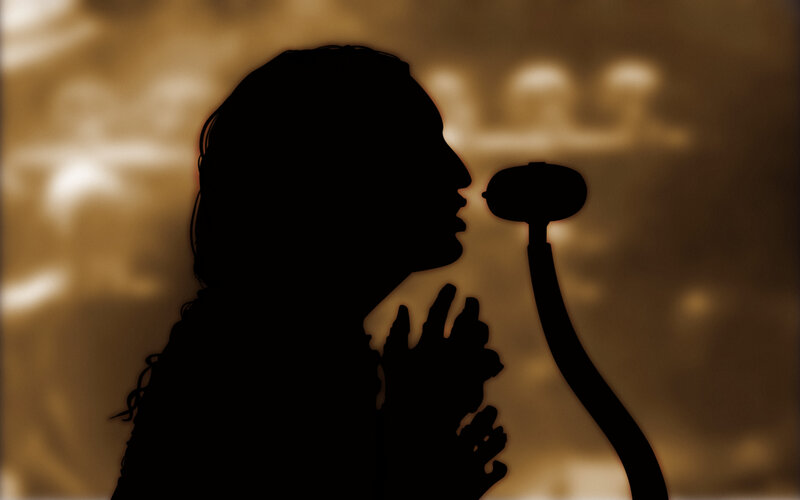 silhouette of singer at microphone