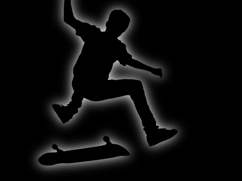 silhouette of skateboarder in action