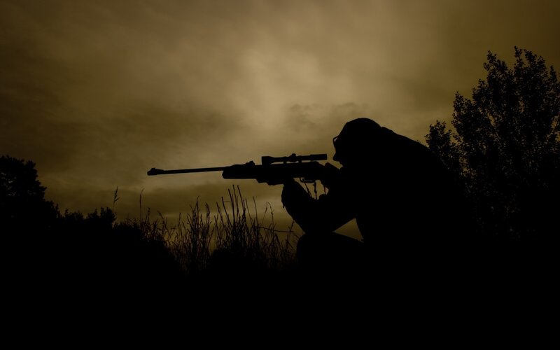 silhouette of sniper at dusk
