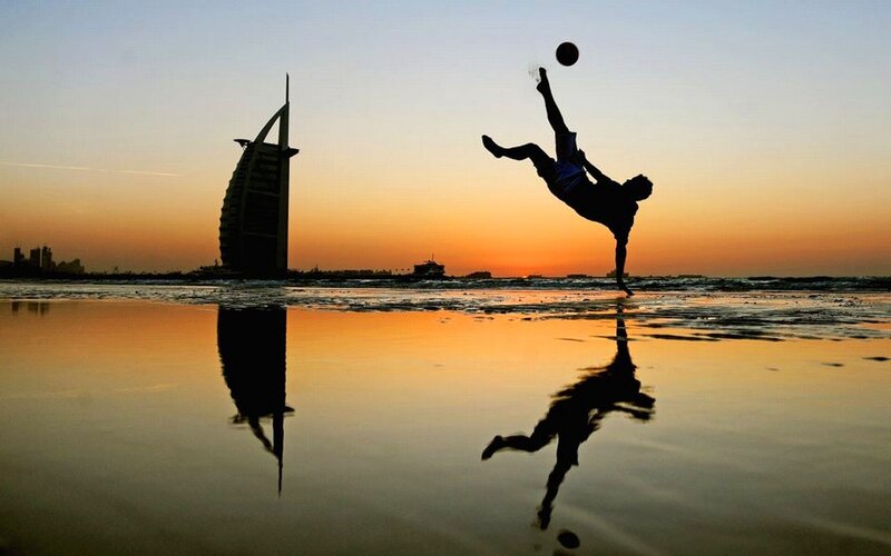 Silhouette of soccer player at sunset