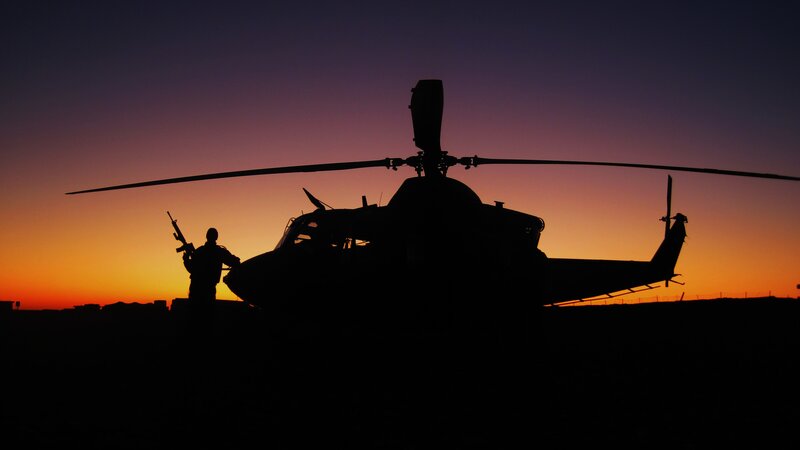 Silhouette of soldier and helicopter