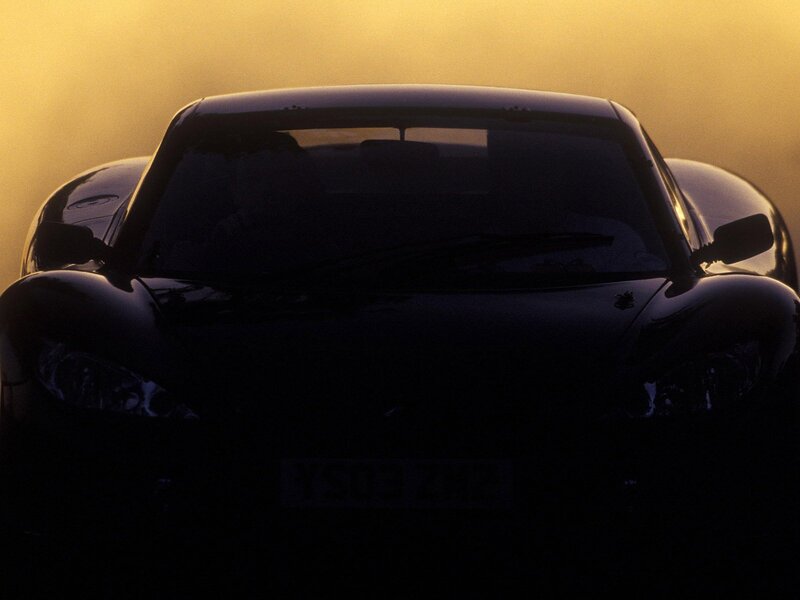 silhouette of sports car at sunset