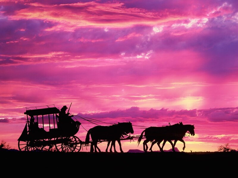 Silhouette of stagecoach at sunset