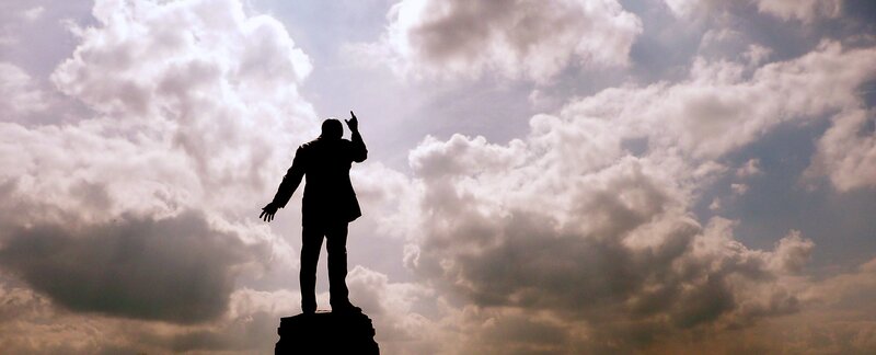 silhouette of statue against cloudy sky