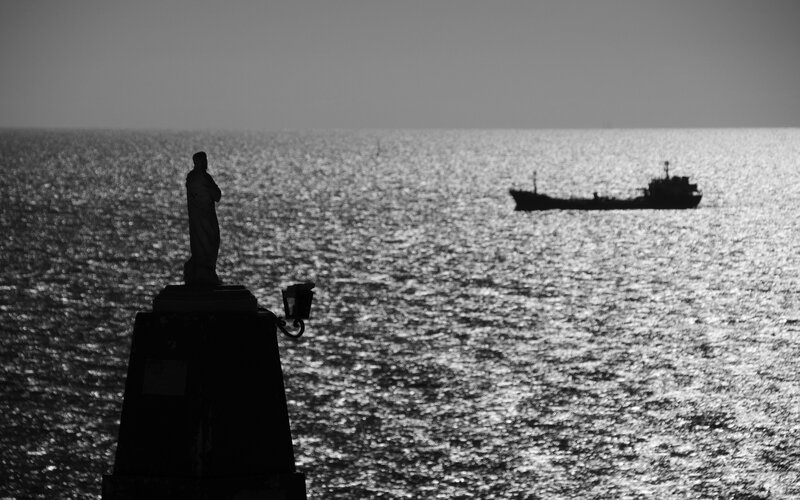 Silhouette of Statue and Ship