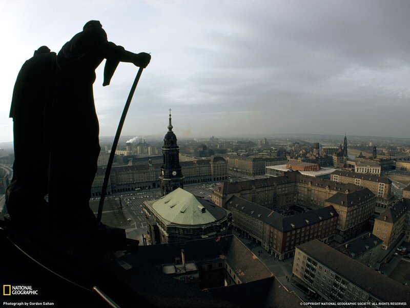 Silhouette of statue overlooking city