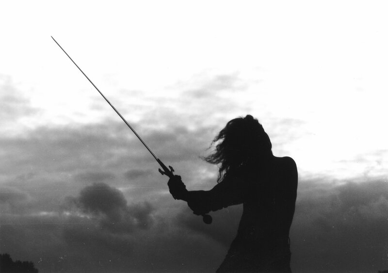 silhouette of swordsman at dusk