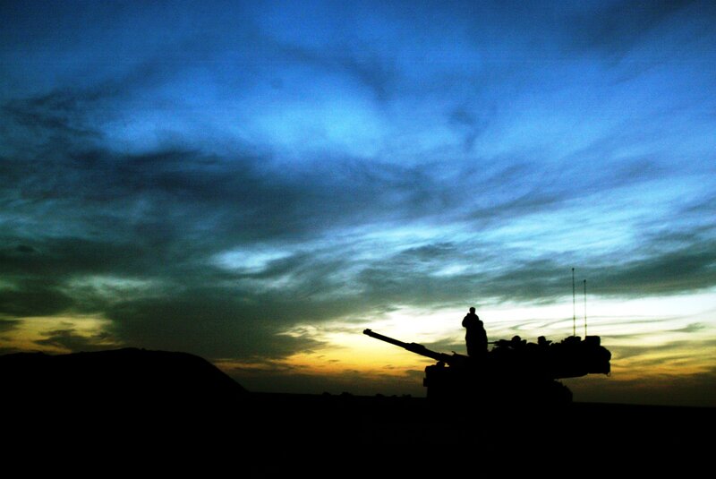 Silhouette of tank at sunset