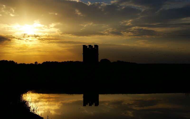 Silhouette of tower at sunset