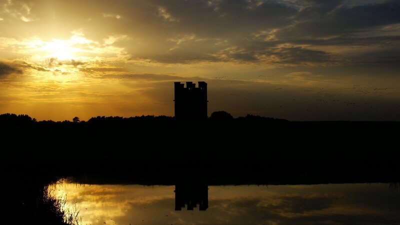 Silhouette of tower at sunset