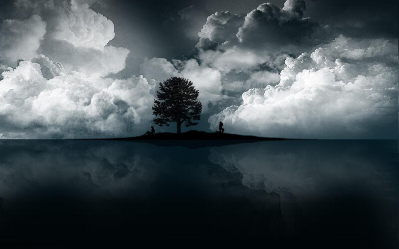 Silhouette of tree and figures on island
