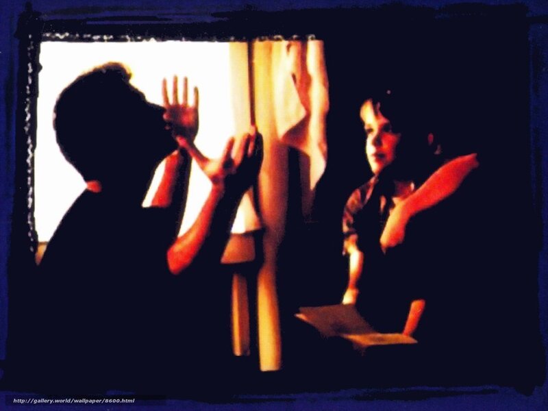 Silhouette of two people at window