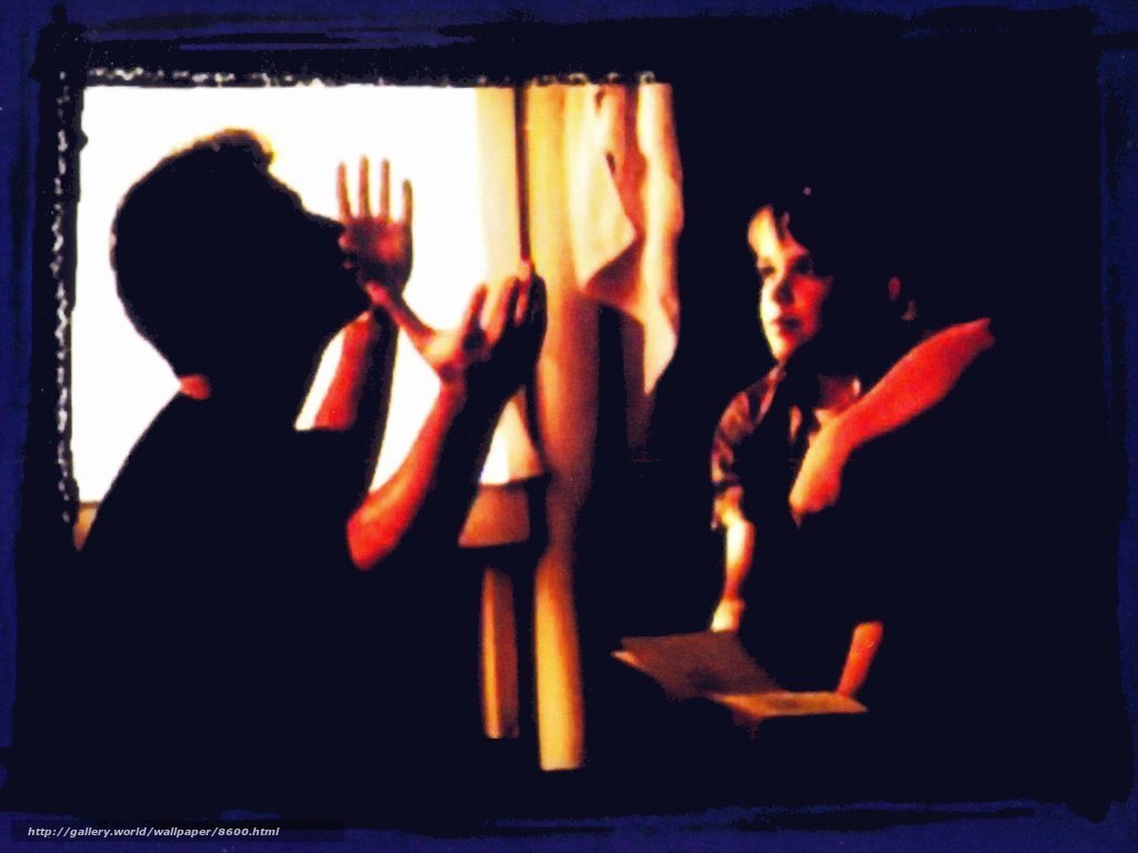 Silhouette of two people at window