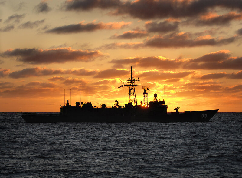 Silhouette of warship at sunset