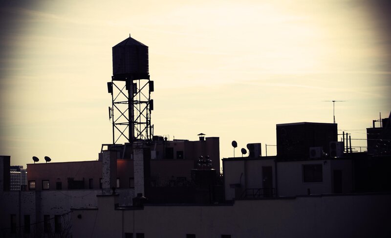 silhouette of water tower at dusk