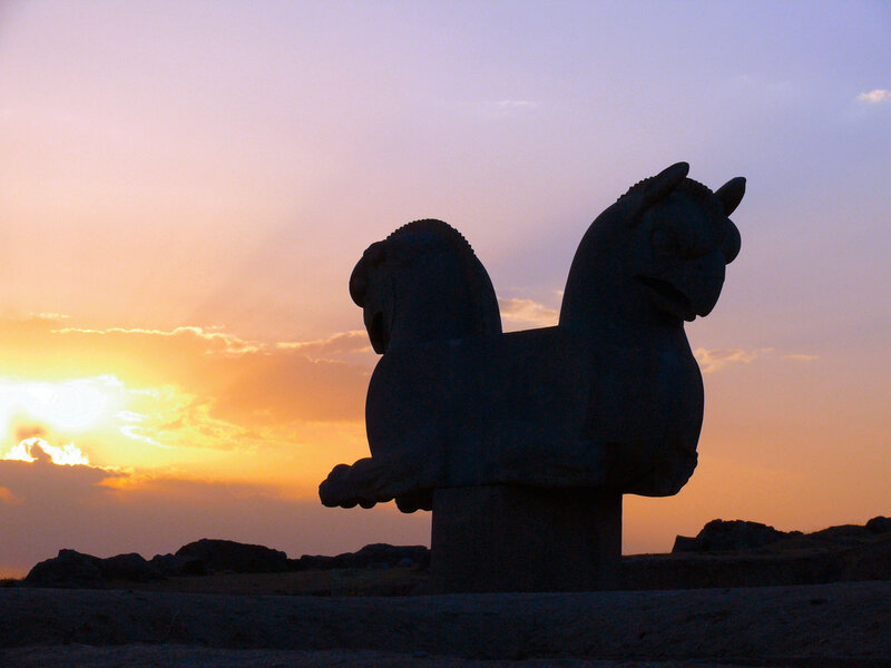 Silhouette of winged lion at sunset