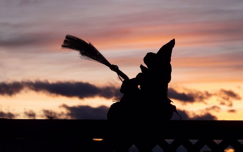 silhouette of witch on broom