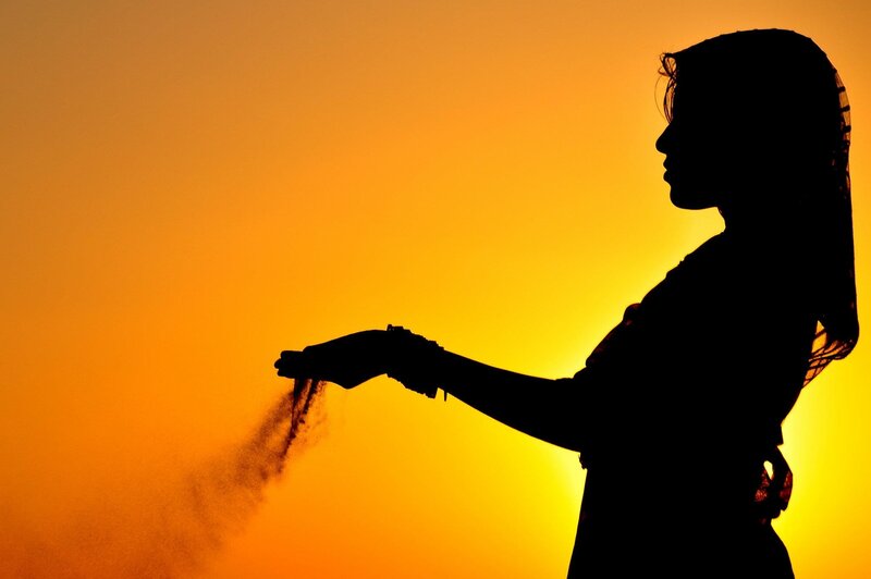 silhouette of woman at sunset
