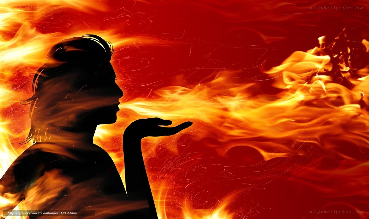 silhouette of woman blowing fire