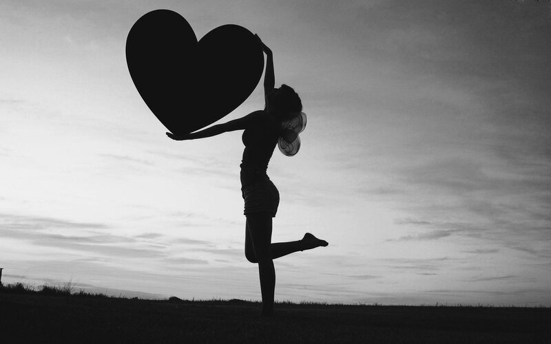 Silhouette of Woman Holding Heart — Black, Dramatic